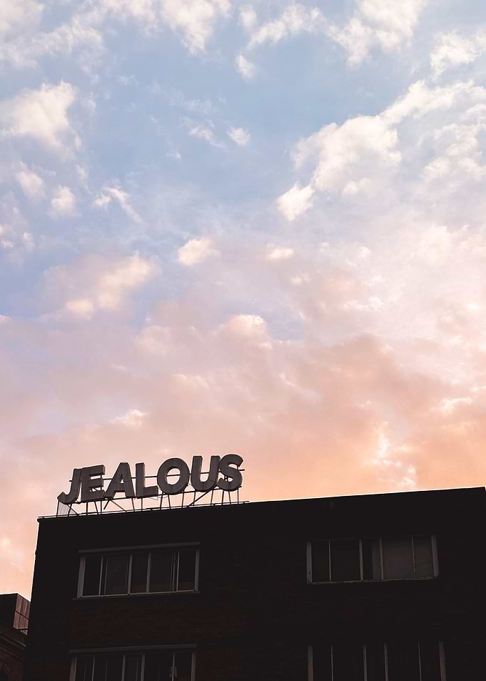 London, England I Jealous word in silhouette against a vibrant pastel pink and blue sunset sky minimalist urban architecture and the delicate boho bohemian aesthetic of a summer evening night