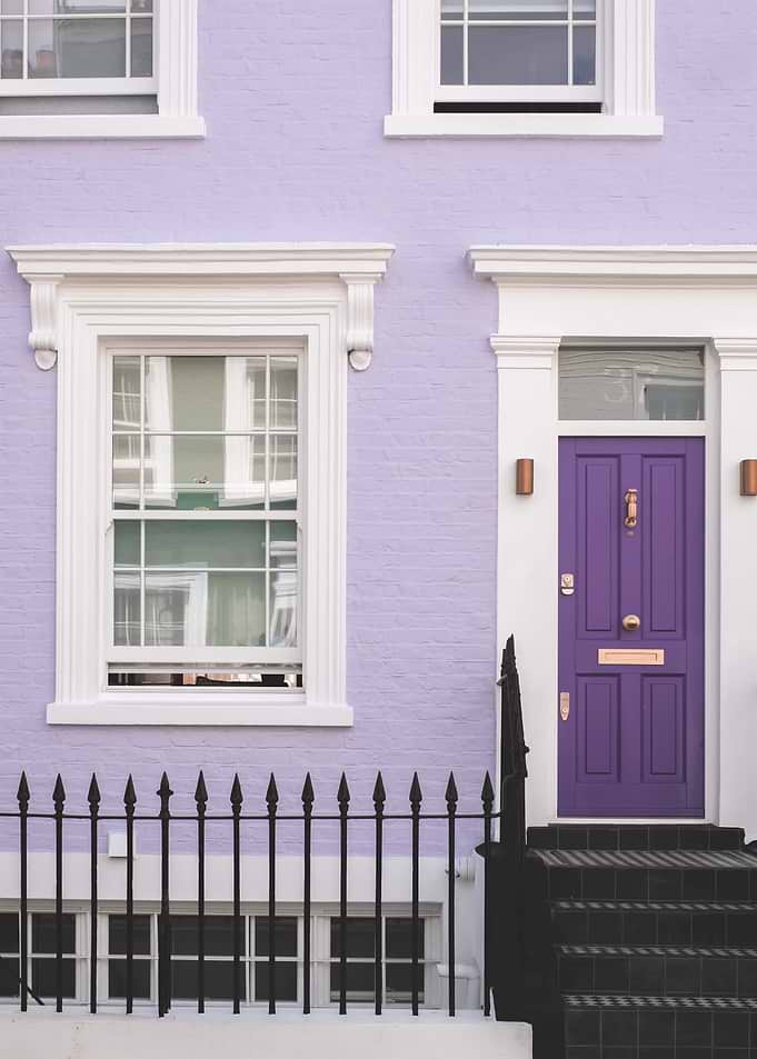 London, England I Front of a typical purple Notting Hill house with colorful brick architecture with minimalist geometric street photography at the retro vintage British vibrant mauve door