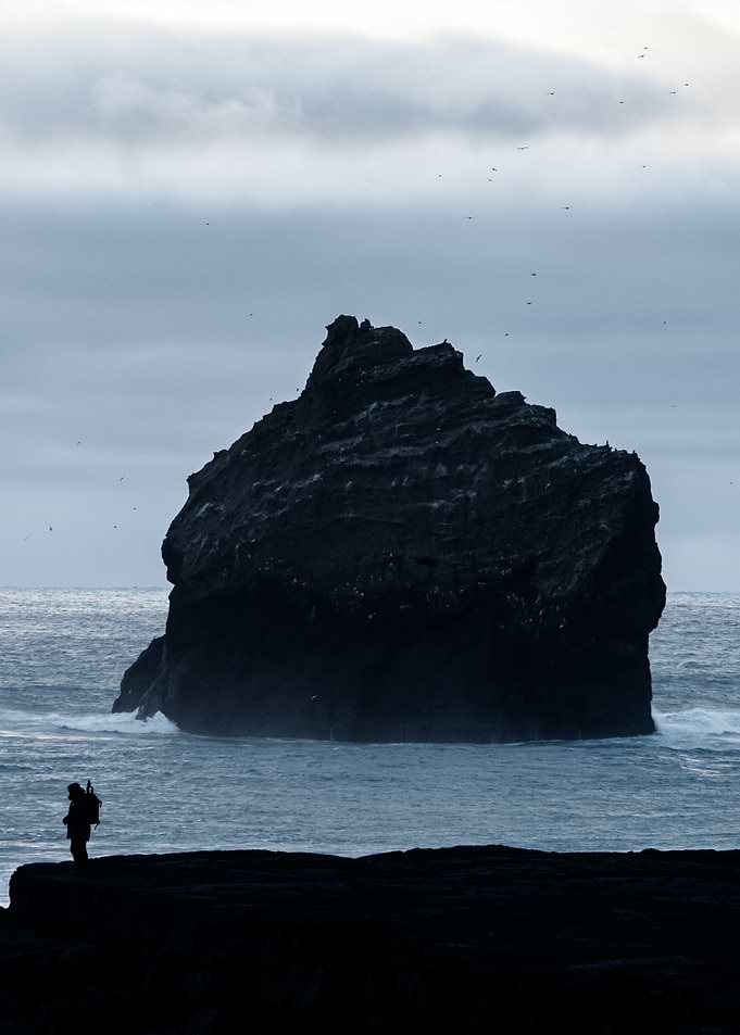 Solitary Figure by Sea Stack
