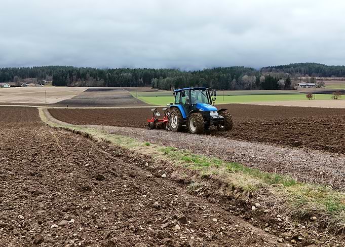 New Holland Tractor Plowing Field