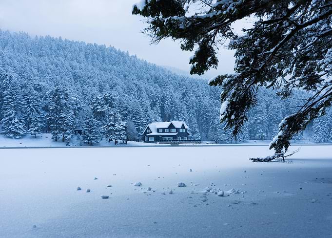 Snowy Cabin by the Lake