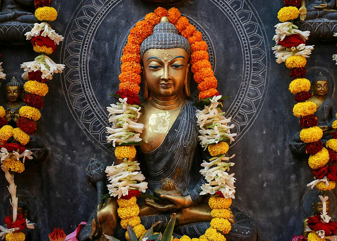 Buddha Statue with Flower Garlands