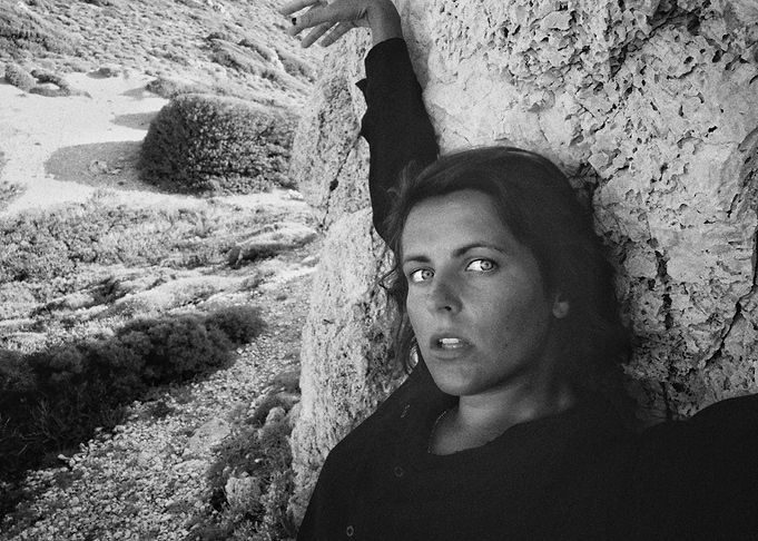 Woman Leaning Against Rock
