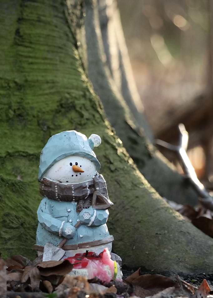 Snowman Figurine in Woods