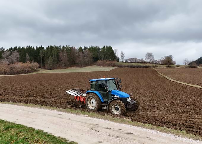 New Holland Tractor Plowing Field