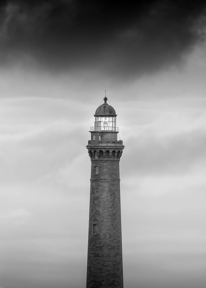 Lighthouse Under Stormy Sky