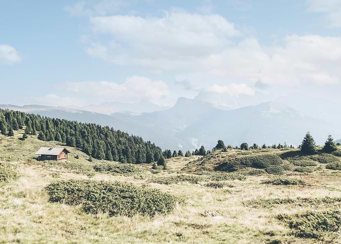 Dolomites, Italy I Isolated wooden chalet in the Alpe di Suisi mountains with panoramic view skyline between fir forests natural landscapes and green plains in an Alps country farm decor setting