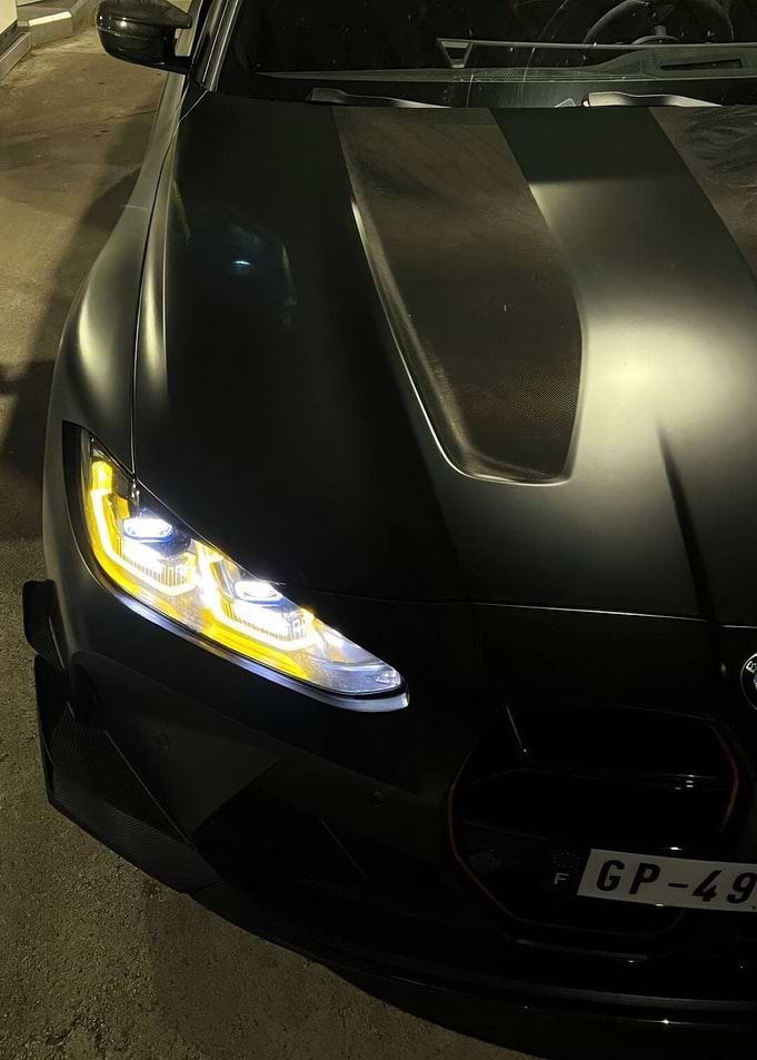 Black BMW M4 with Yellow Headlights