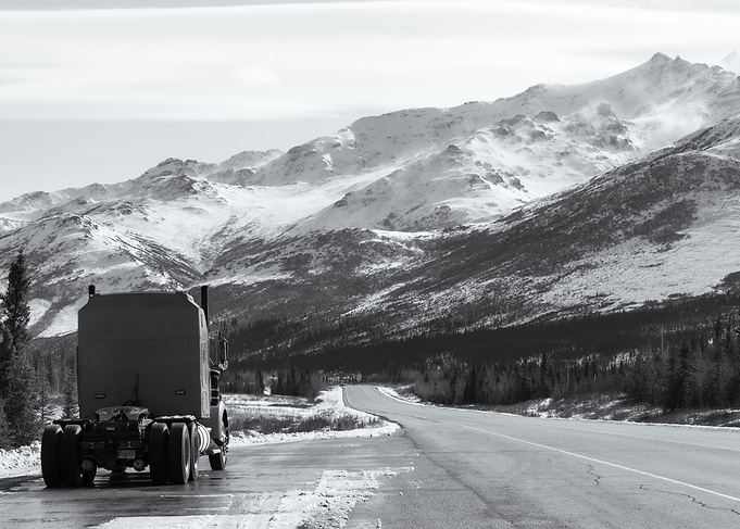 Truck on Snowy Mountain Road