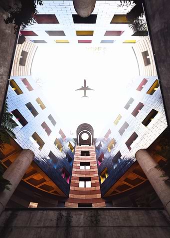 Airplane Over Modern Building