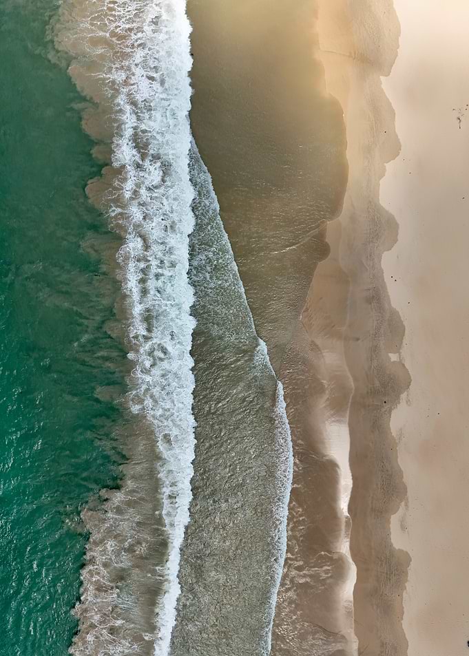 Aerial View of Ocean Waves and Beach