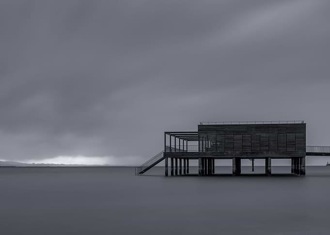 Monochrome Pier Structure in Calm Water