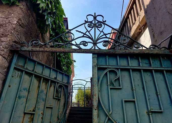 Ornate Metal Gate Leading to Garden