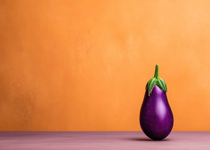 Single Eggplant on Orange Background