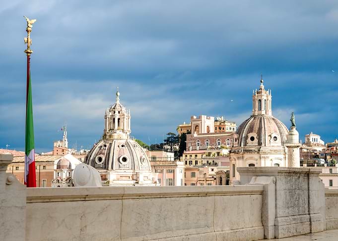 Rome cityscape with domes and flag