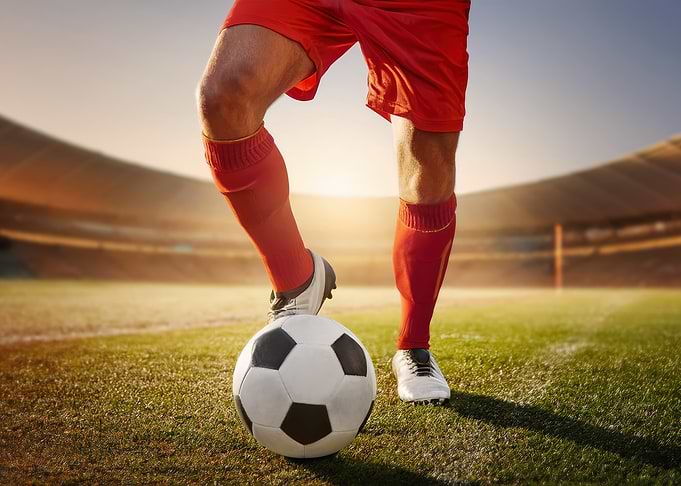 Soccer Player with Ball in Stadium