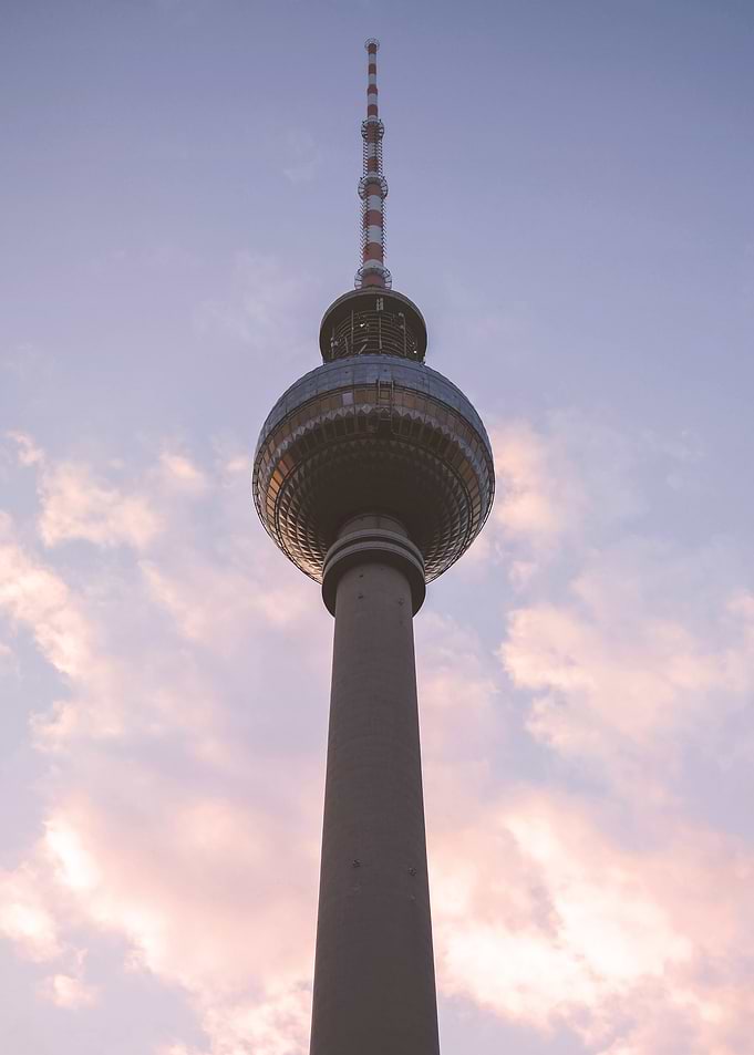 Berlin, Germany I Minimalist silhouette of the Fernsehturm Tower at sunset with pastel pink blue sky for a geometric and abstract cityscape shot in golden hour with poetic urban industrial photography