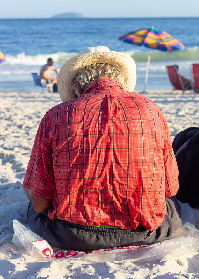 Man in Hat and Red Shirt on Beach