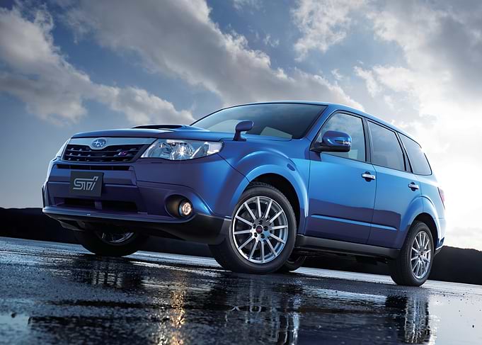 Blue Subaru Forester STI on Wet Surface
