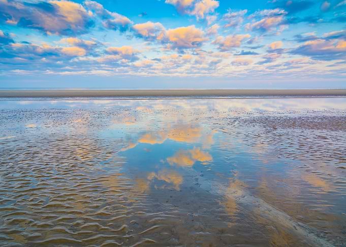 Reflective Beach at Sunrise