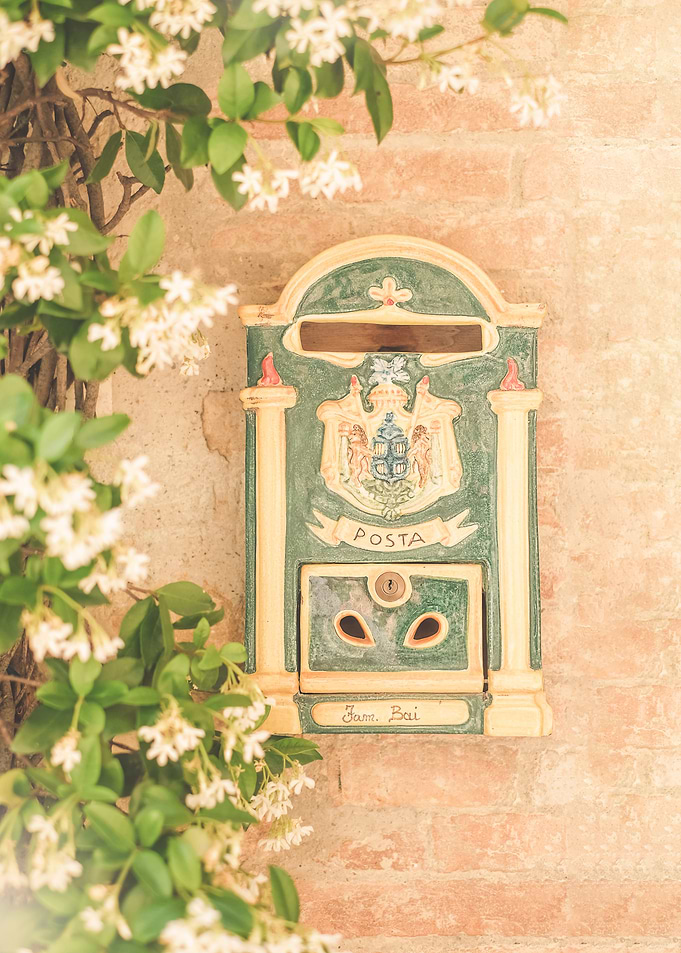 Tuscany, Italy I Italian ceramic mailbox in Pienza with star jasmine on rustic stone wall in vintage countryside photography with Mediterranean pastel aesthetic, poetic dolce vita Italian summer vibes