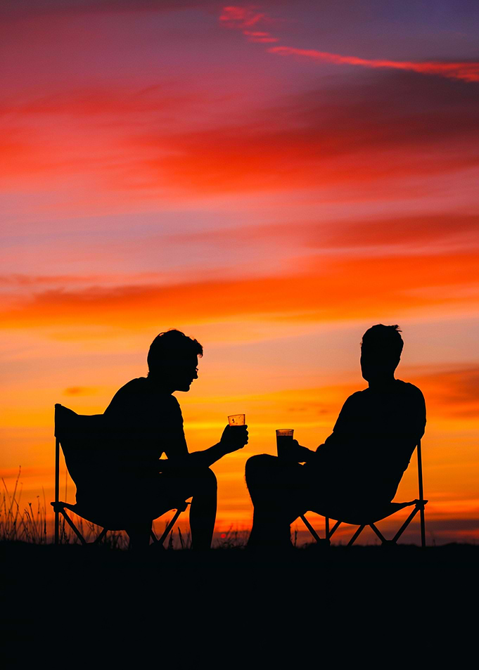 Fiery Horizon – Silhouetted Campers Under a Blazing Sky