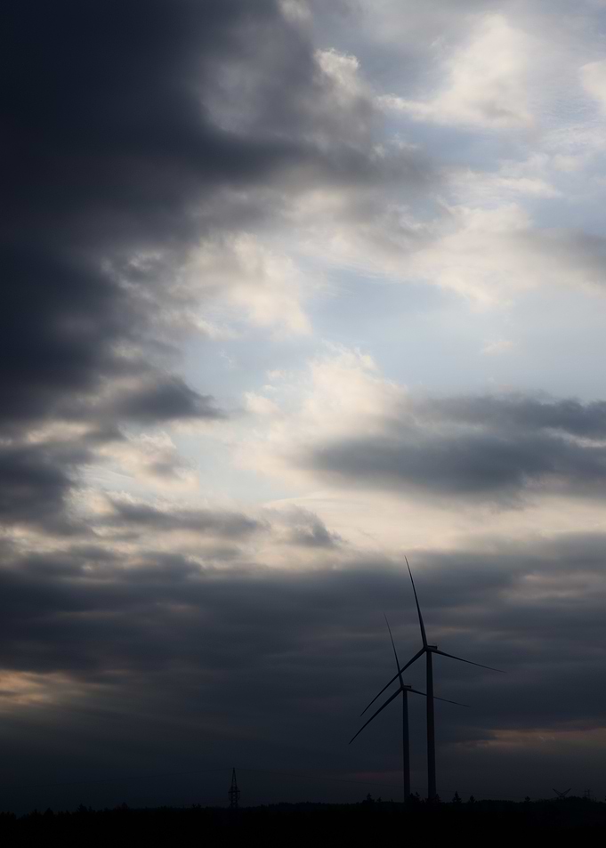 Wind Turbines Under Cloudy Sky