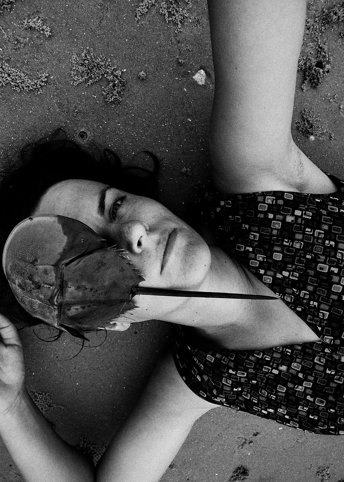 Woman with Horseshoe Crab on Beach