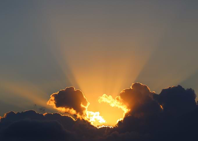 Golden Sunset Through Clouds