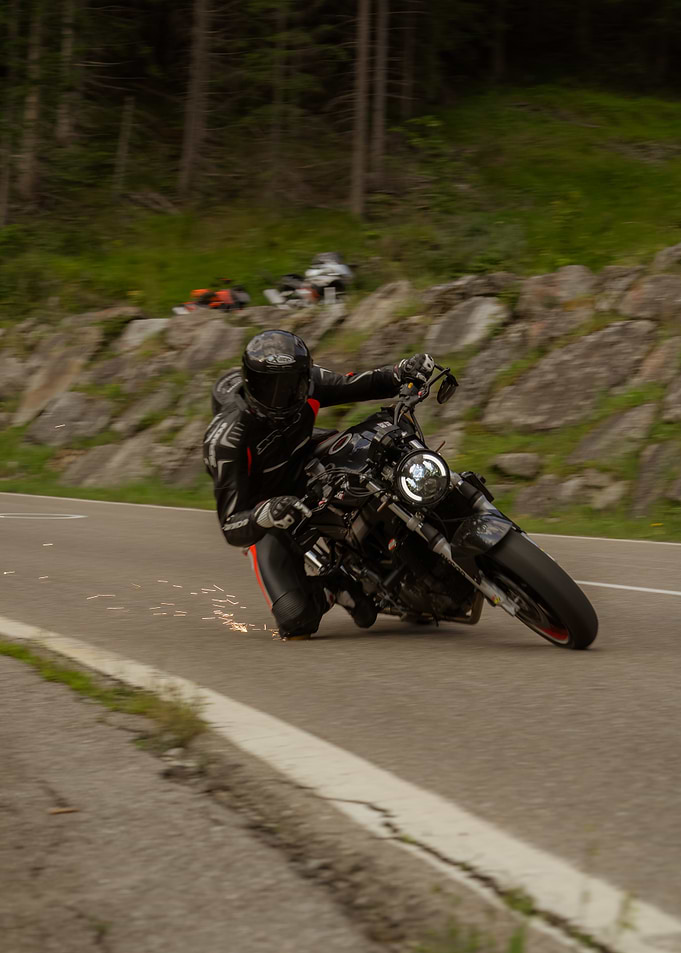 Motorcycle rider cornering on mountain road