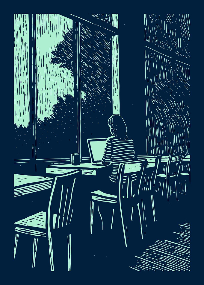 Woman working at cafe window seat