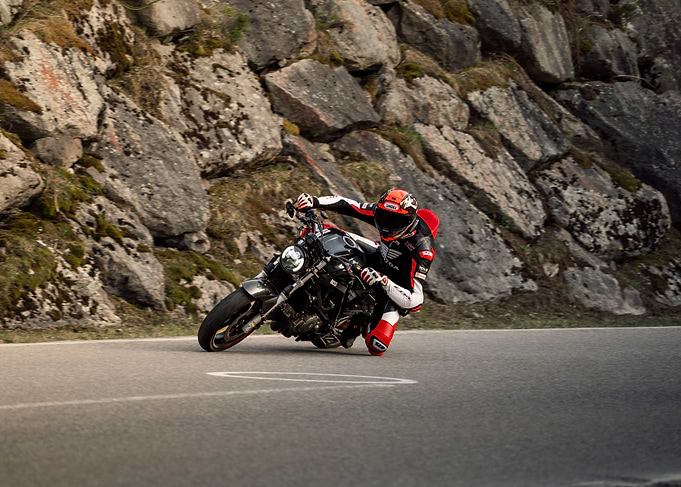 Motorcycle rider cornering on mountain road