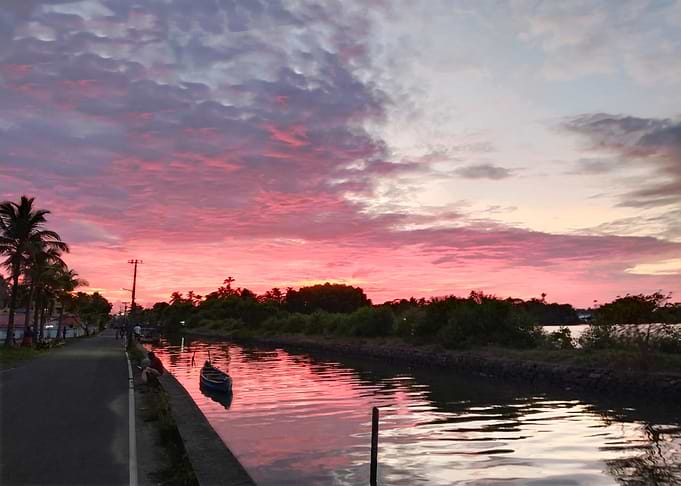 Pink Sunset over Canal with Boat