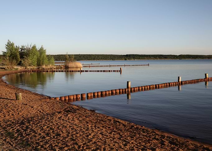 Calm Lake Scene with Wooden Barriers