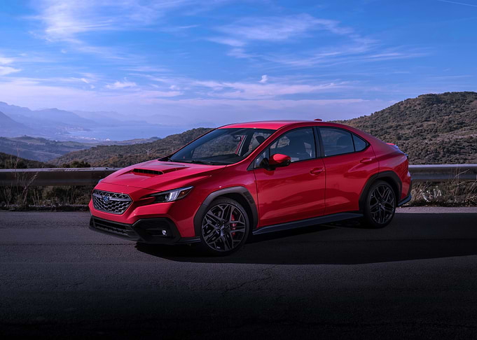 Red Subaru WRX on Mountain Road