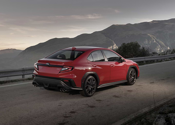 Red Subaru WRX on Mountain Road