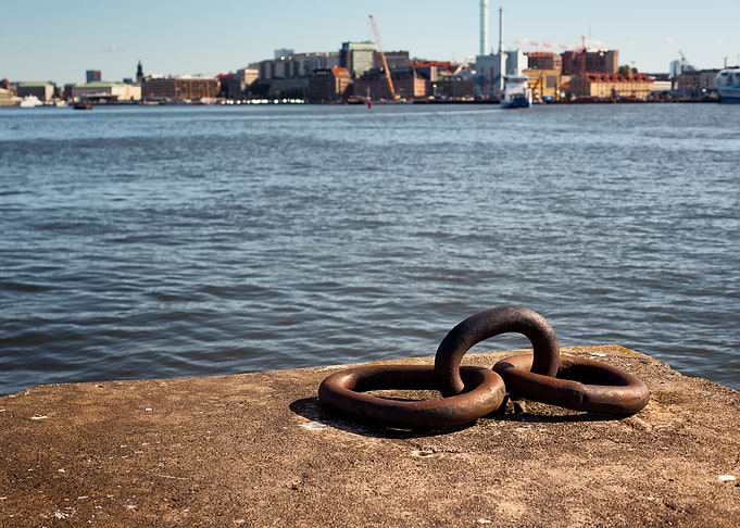 Rusty Chain Rings on Concrete Pier