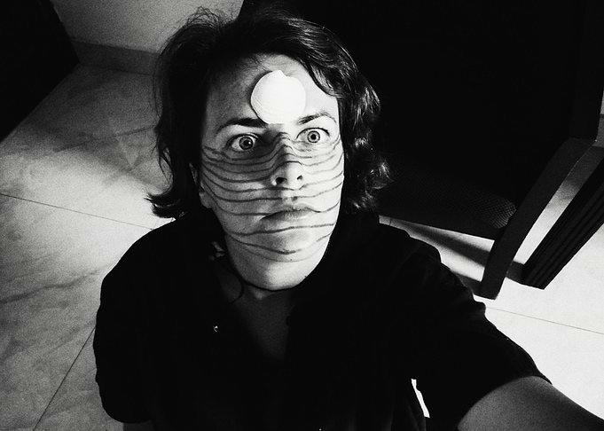 Monochrome portrait with face paint and shell