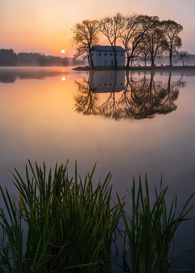 Sunrise over the lake with building