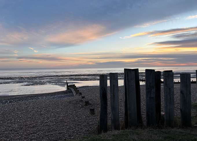 Beach Sunset with Wooden Posts