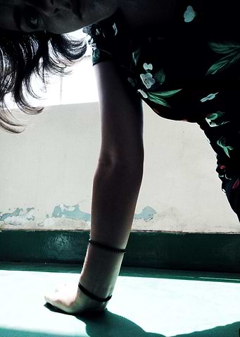 Woman in Floral Dress Bending Over