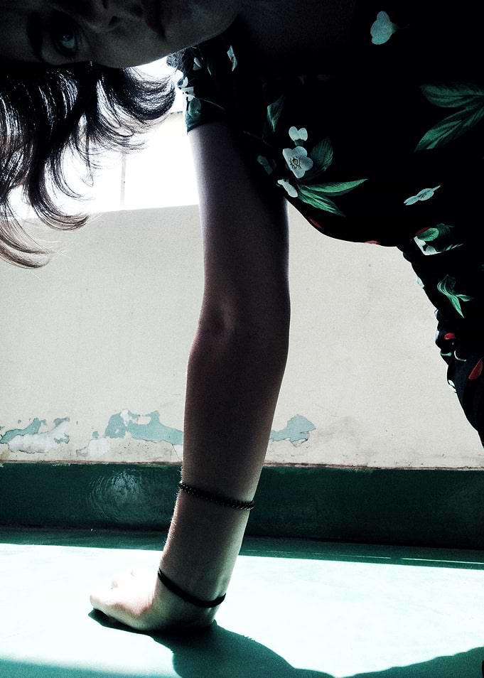 Woman in Floral Dress Bending Over