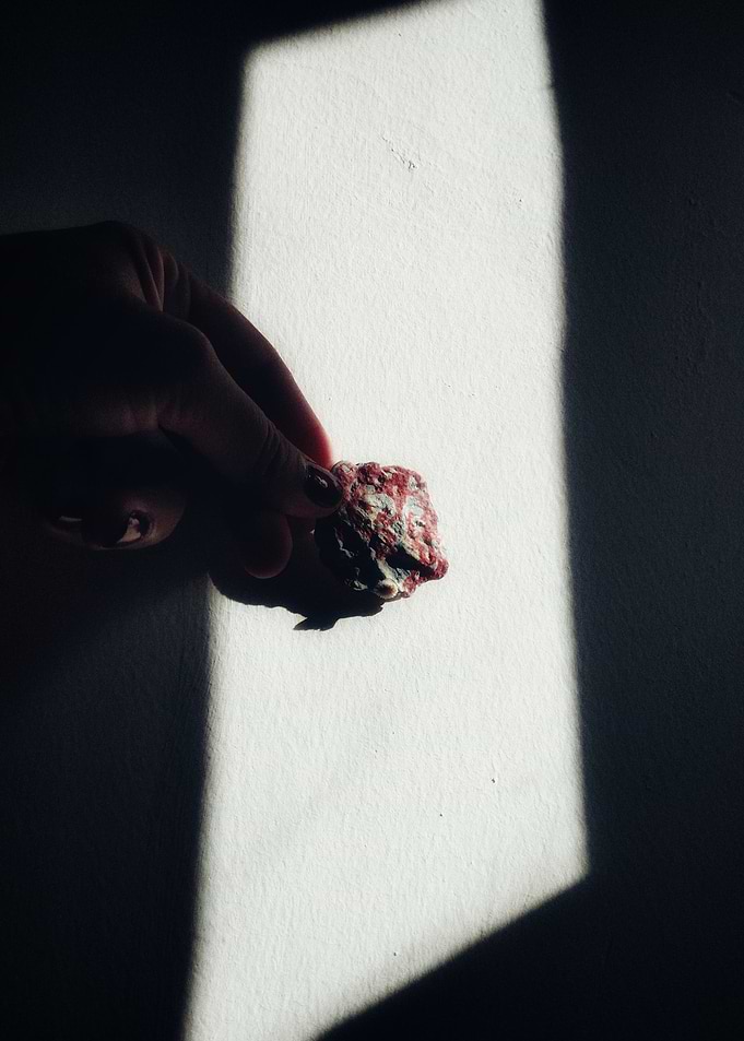 Hand holding a mineral specimen