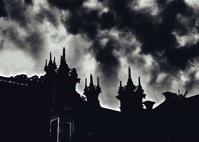 Dark Temple Silhouette Under Stormy Sky