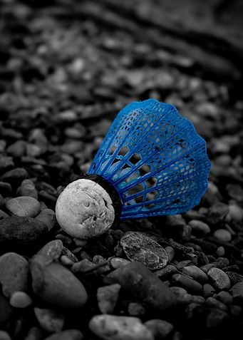 Blue Badminton Shuttlecock on Pebble Ground