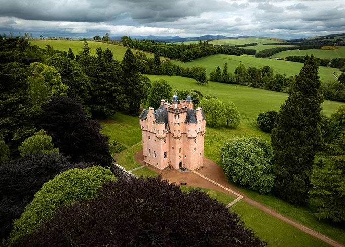 Castle surrounded by green landscape in Scotland
