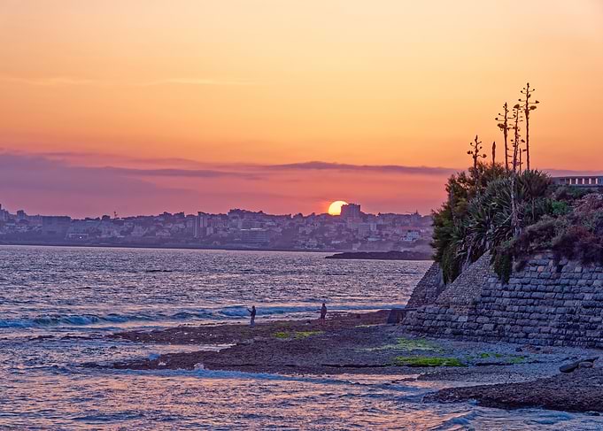Coastal Sunset with Cityscape