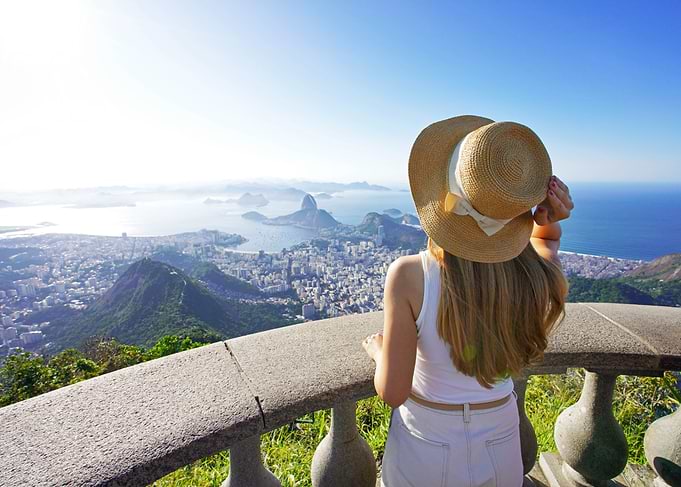 Woman with hat overlooking on Corcovado in Rio de Janeiro, Brazil