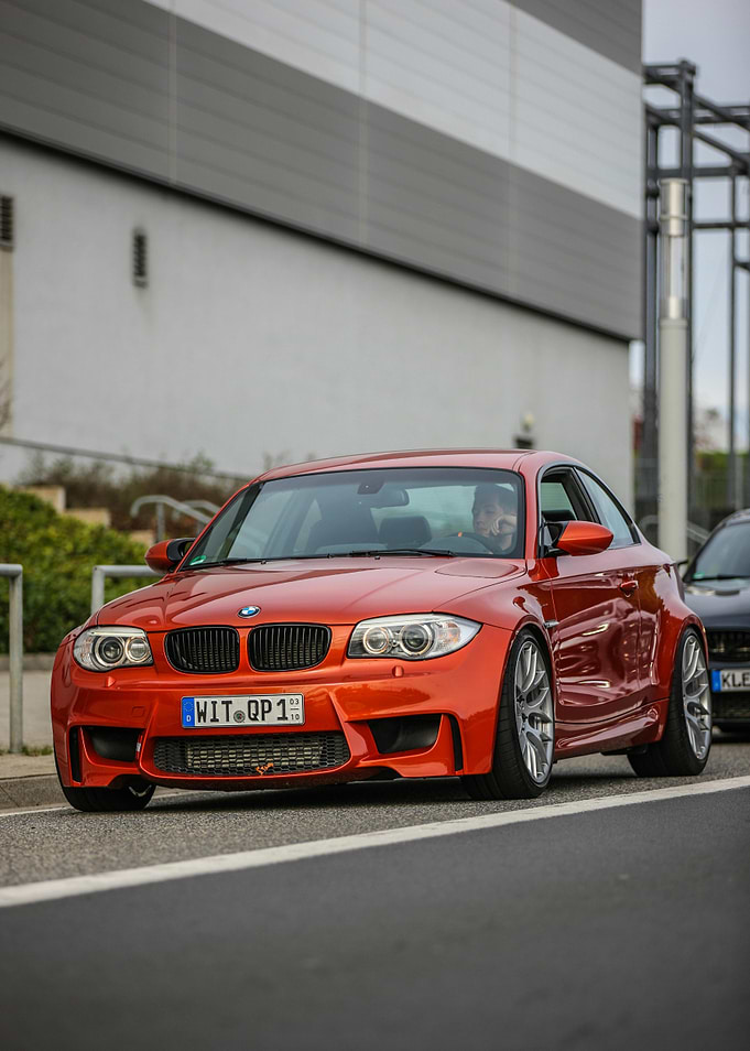 Orange BMW 1M Coupe on Street
