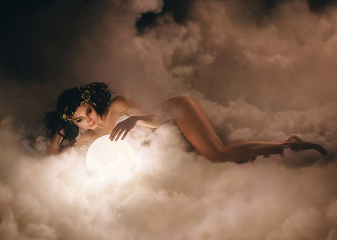 Woman with Glowing Orb in Clouds